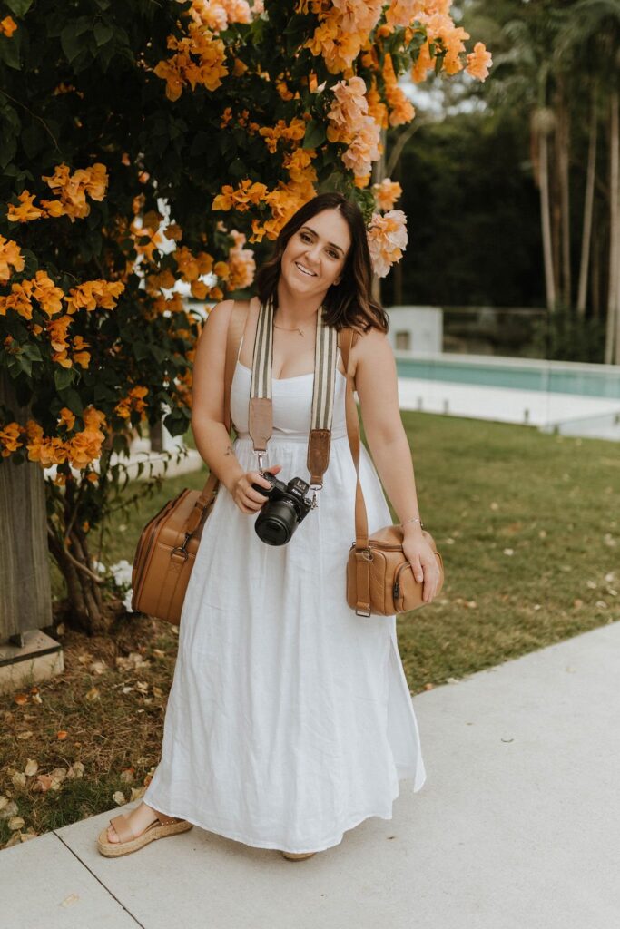 Emily Vale, Sunshine Coast photographer, holding her camera